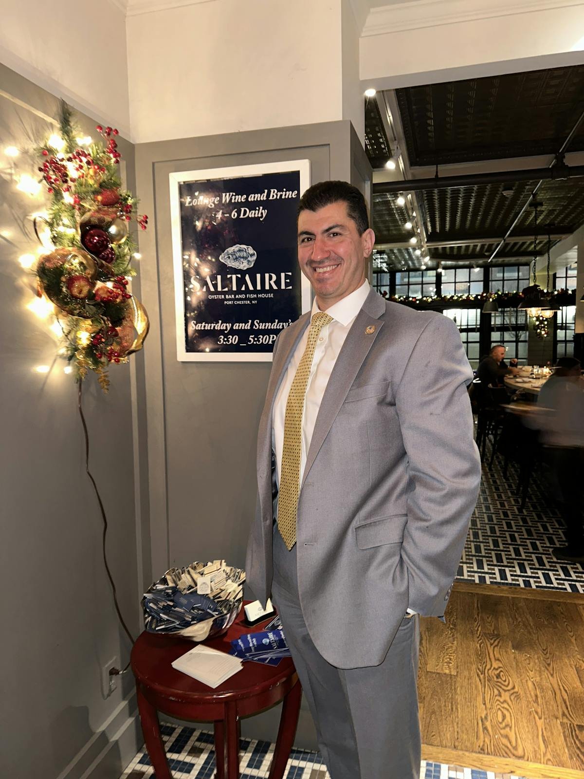 a man wearing a suit and tie standing in a room